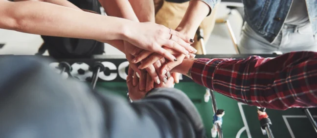 friends-together-play-board-games-table-football-have-fun-free-time 1